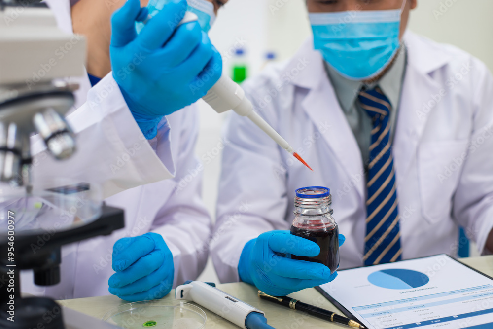 A modern laboratory scene showcasing scientists, both male , in lab coats, analyzing samples using microscopes and computers. A modern laboratory scene showcasing scientists, both male , in lab coats, analyzing samples using microscopes and computers.