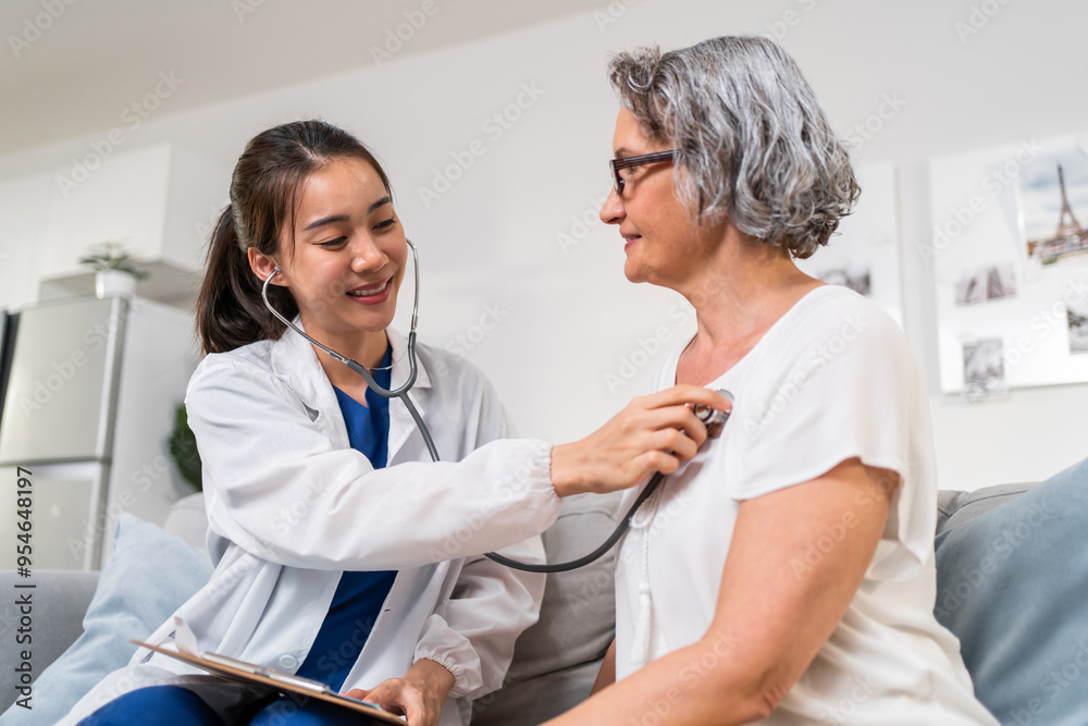 Fototapeta premium Asian caregiver doctor examine and listen heart rate senior woman patient. 