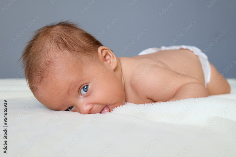 Healthy newborn wearing only a diaper laying shirtless on the bed with curious expression on her face, copy space for advertisement or promotional content Healthy newborn wearing only a diaper laying shirtless on the bed with curious expression on her face, copy space for advertisement or promotional content
