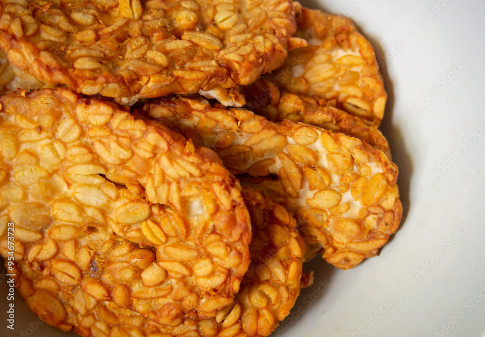 Crispy fried tempe, a typical Indonesian food on a white background