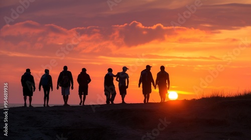 A group of friends strolls along the beach during sunset, enjoying the warm colors of the sky as the sun sets on the horizon photo