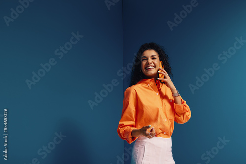 Confident female entrepreneur in vibrant, monochromatic office setting with bold color blocking
