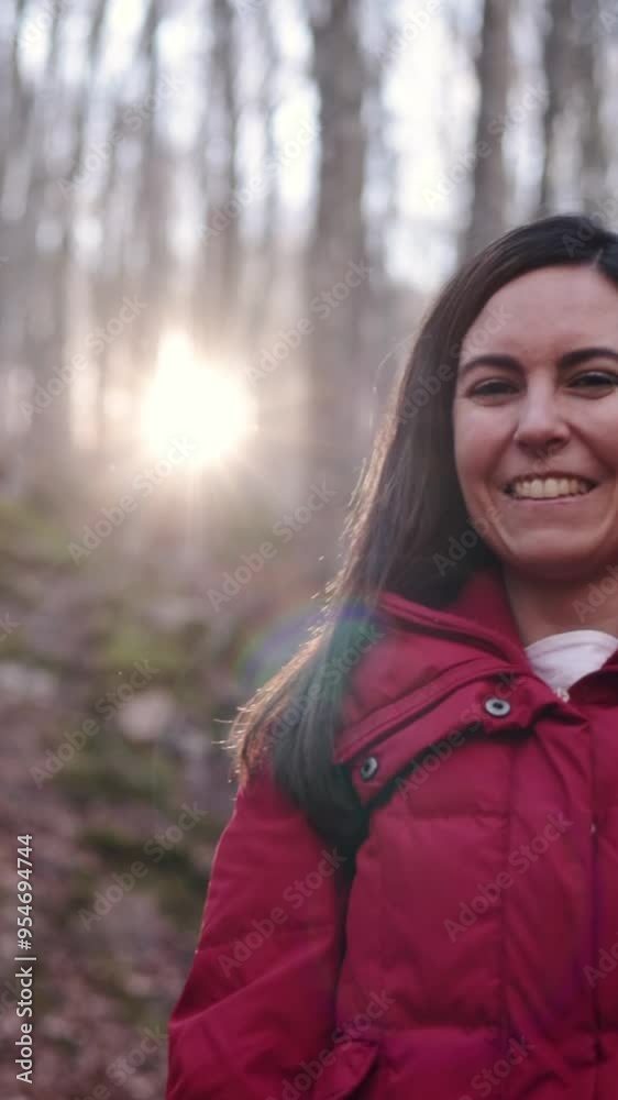 Pretty woman wearing a red jacket laughing in forest at sunset. Copy space. Pretty woman wearing a red jacket laughing in forest at sunset. Copy space.