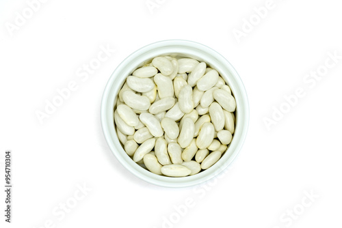 White beans or navy beans or pearl haricot beans or pea beans in white ceramic cup isolated on white background top view flat lay.