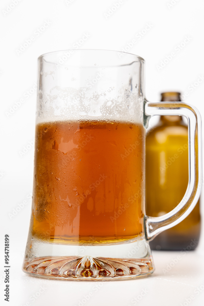 Frosty Beer Jug with Empty Bottle in Background Frosty Beer Jug with Empty Bottle in Background