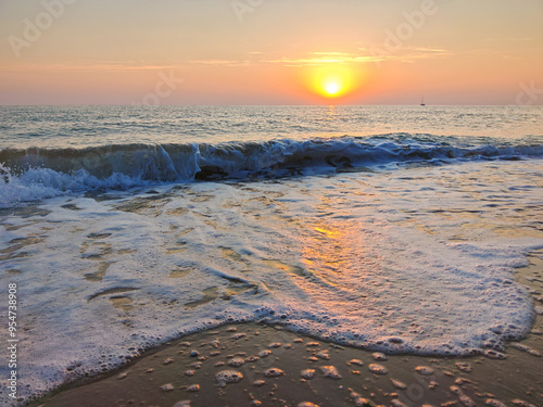 Beautiful sunrise on the Mezzavalle beach during summer day of august, Park of Monte Conero, Italy photo