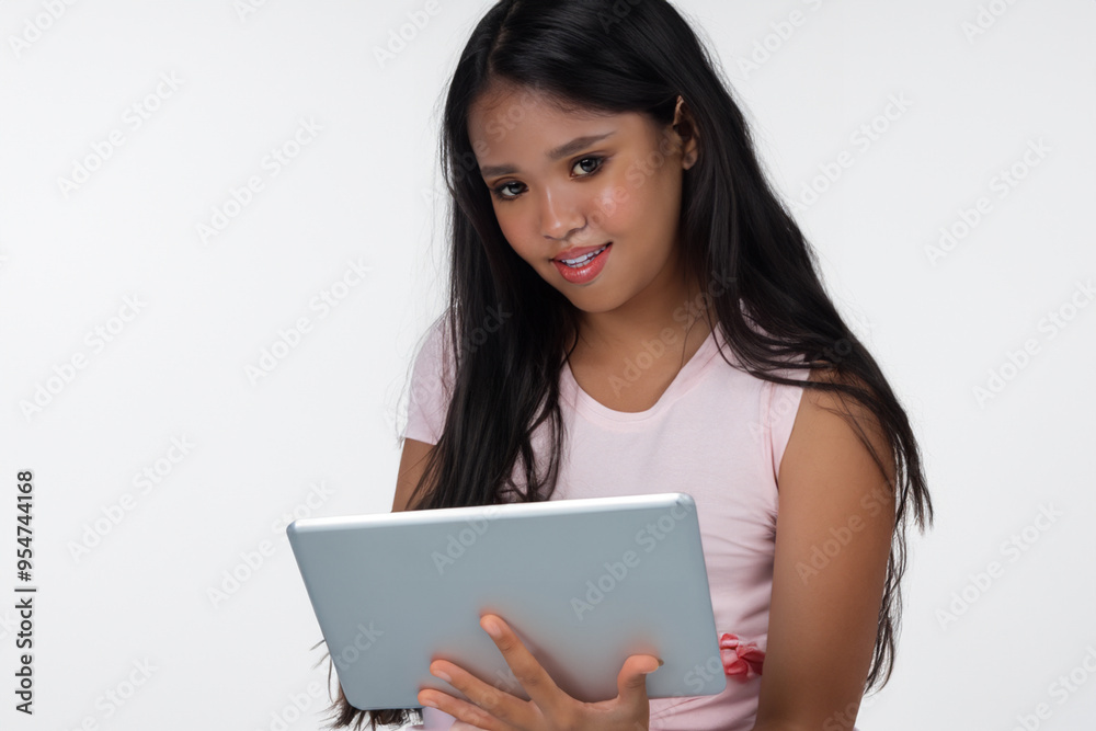 Girl is using tablet on white . person computer young concept. girl is using technology on tablet with a light on the . a girl is using technology on a white with lifestyle a tablet. Girl is using tablet on white . person computer young concept. girl is using technology on tablet with a light on the . a girl is using technology on a white with lifestyle a tablet.