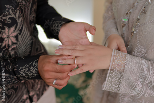Engagement ring pinning. Showing of the engagement ring. Holding hands. Concept of engagement photo. Indonesian couple