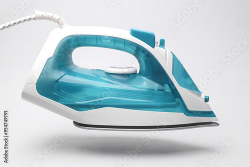 Floating Modern iron for ironing on a white background