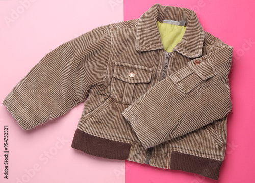 Children's corduroy jacket on pink background. Top view