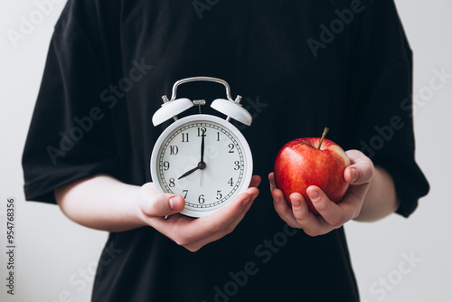 Time management concept with apple and alarm clock