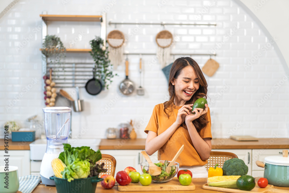 Portrait of beauty health asian woman having fun hold avocado cooking, vegan food healthy eat, fresh vegetable, cholesterol, vitamins, HDL, vegetarian in kitchen.Diet.Fitness, healthy food Portrait of beauty health asian woman having fun hold avocado cooking, vegan food healthy eat, fresh vegetable, cholesterol, vitamins, HDL, vegetarian in kitchen.Diet.Fitness, healthy food
