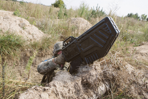 Ukrainian soldier in trench with anti-drone gun.