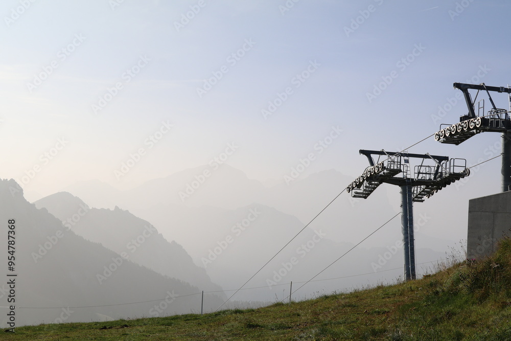 silhouette of cable car masts with a monochrome background of mountains in the fog silhouette of cable car masts with a monochrome background of mountains in the fog