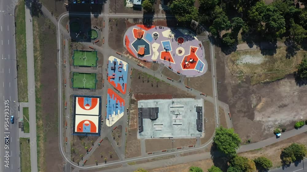 Aerial view on different modern sport grounds at urban park. Youth, teenagers and children engaging in various sports at contemporary playgrounds. Concept of popularize a healthy lifestyle