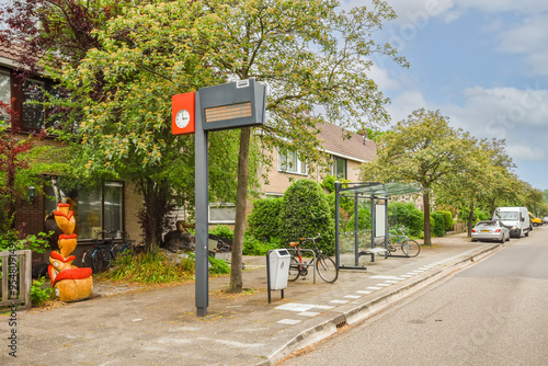 Suburban street scene with bus stop and sculptures photo