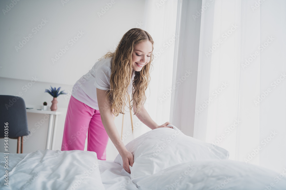 Portrait of sweet cute teen lady making bed fix pillow wear nightwear wake up bedroom light interior house indoors Portrait of sweet cute teen lady making bed fix pillow wear nightwear wake up bedroom light interior house indoors