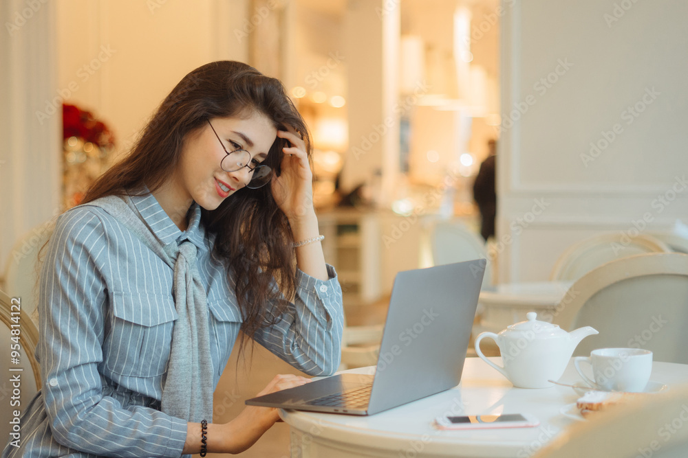 Woman is working on the pc at the internet cafe Woman is working on the pc at the internet cafe