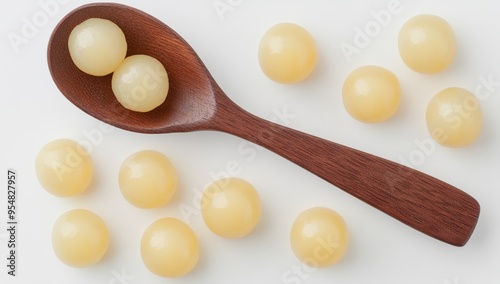 Toor Dal, or split yellow lentils, in a wooden spoon. Split chickpea in a bag, also known as yellow chana split peas, dried chickpea lentils, or toor dal, isolated on white.