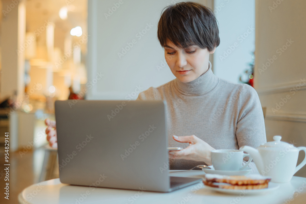 Woman is working on the pc at the internet cafe Woman is working on the pc at the internet cafe