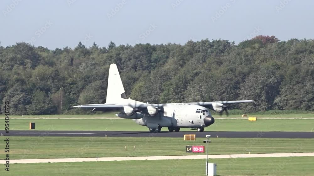 military transport plane taxis runway dutch airport, preparing for next mission plane's robust design reliability make critical asset for military airplane taxiing logistics troop transport military transport plane taxis runway dutch airport, preparing for next mission plane's robust design reliability make critical asset for military airplane taxiing logistics troop transport