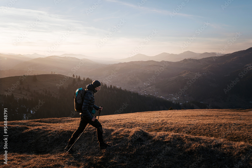 Fototapeta premium Solo Hiker Walking at Sunset on Mountain Ridge