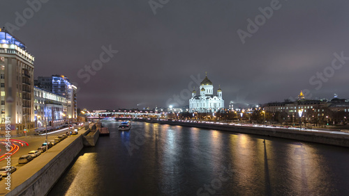Majestic orthodox Cathedral of Christ Saviour illuminated at dusk on bank of Moscow river. Timelapse hyperlapse, Russia