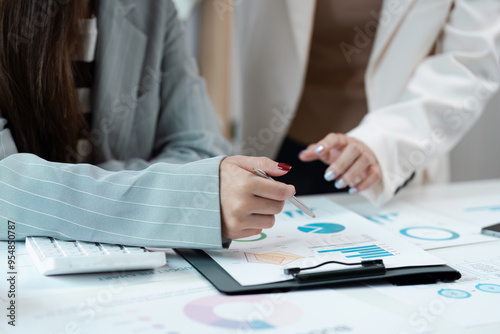 Business Professionals Analyzing Financial Data and Charts in a Modern Office Setting