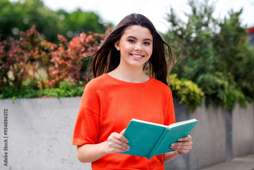 Fototapeta premium Photo of attractive teen cheerful girl read book relax wear red garment having fun outside outdoors