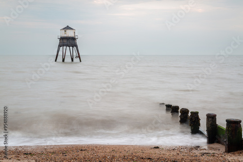 Lighthouse in the sea long exposure, Dovercourt lighthouse at high tide built in 1863 and discontinued in 1917 and restored in 1980 the lighthouse is still a iconic sight on a cloudy evening  photo