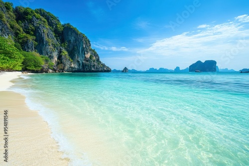 Scenic tropical beach with crystal clear blue waters and white sandy shores.