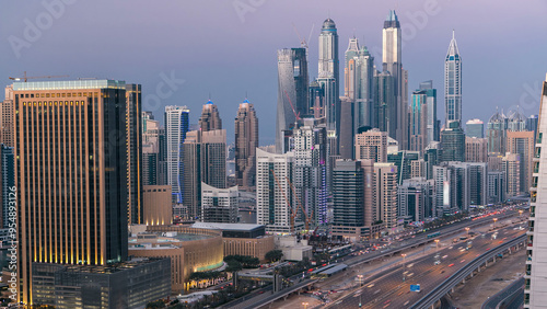 Aerial top view day to night timelapse of Dubai Marina and JLT in Dubai, UAE photo