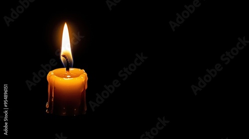 A single lit candle flickering softly against a dark background creating a serene and peaceful atmosphere photo