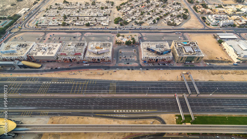 Aerial view of Sheikh Zayed highway road timelapse in Dubai with traffic and a metro station. photo