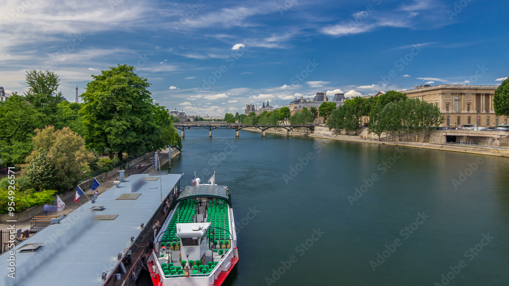Naklejka premium Touristic boat passes below Pont des Arts and stop on boat station on Seine river timelapse hyperlapse in Paris.