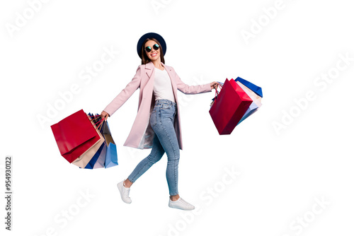 Full length photo of cheerful funky lady tourist in eyewear eyeglasses go shopping buy sales discount wear pink retro vintage coat denim jeans isolated over blue background photo