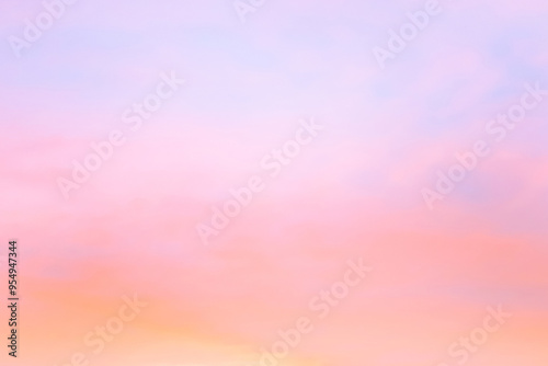 Twilight sky with effect of light in pastel pink, coral, orange, blue tones. Colorful sunset of soft clouds. Background