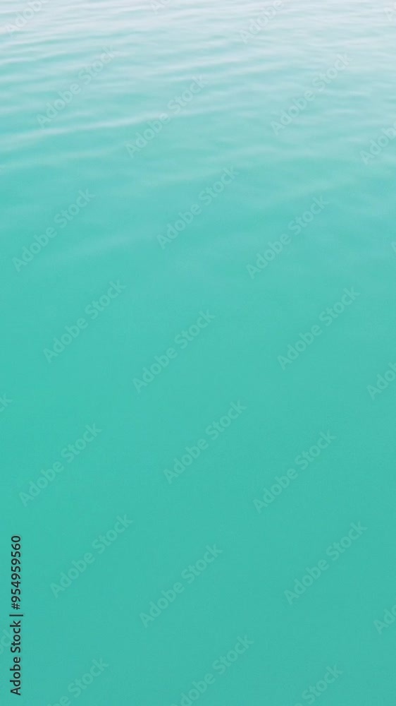 Aerial vertical view on calm azure sea. Small waves on water surface in motion blur. Nature summer ocean sea beach. Nobody. Weather and climate change. Holiday, vacation and travel idea. Aerial vertical view on calm azure sea. Small waves on water surface in motion blur. Nature summer ocean sea beach. Nobody. Weather and climate change. Holiday, vacation and travel idea.