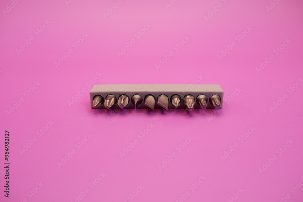 a set of screwdriver bits isolated on purple background a set of screwdriver bits isolated on purple background