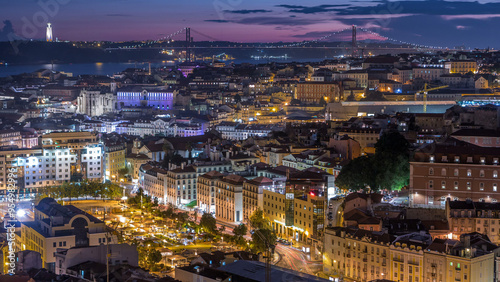 Lisbon after sunset aerial panorama view of city centre with red roofs at Autumn day to night timelapse, Portugal