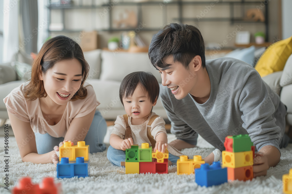 Parents play happily with their children at home. By connecting blocks in the living room. Parents play happily with their children at home. By connecting blocks in the living room.
