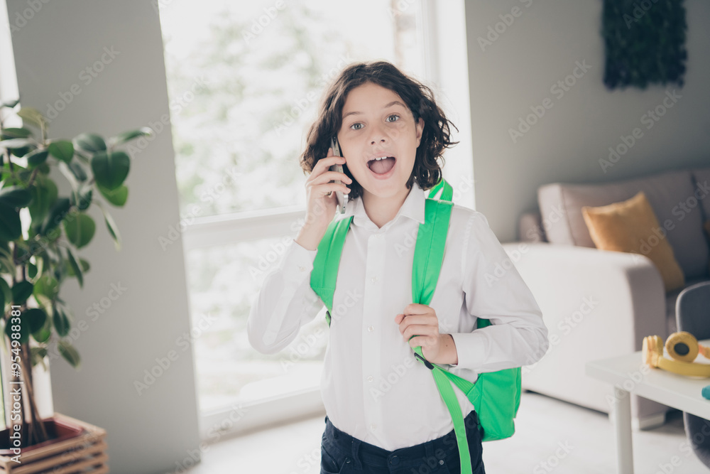 Photo of charming cute small boy schoolchild wearing white shirt speaking phone 1st september morning indoors Photo of charming cute small boy schoolchild wearing white shirt speaking phone 1st september morning indoors