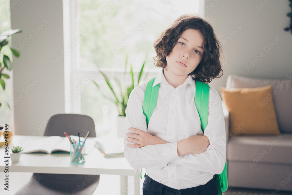 Photo of pretty sad tired boy schoolchild wearing white shirt going to school 1st september morning room indoors Photo of pretty sad tired boy schoolchild wearing white shirt going to school 1st september morning room indoors
