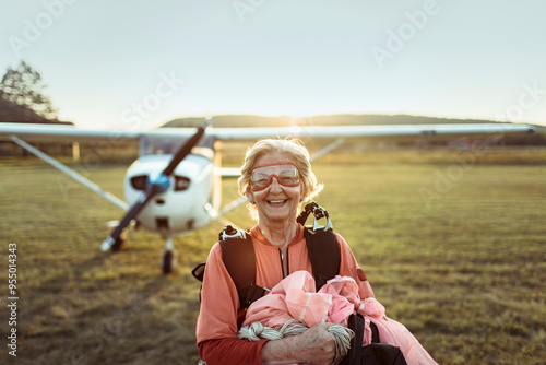 Portrait of a smiling senior woman after landing from skydive photo