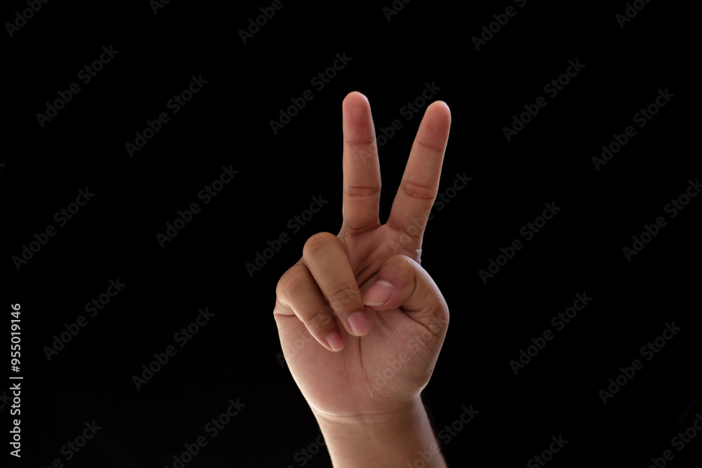 Close-up of one hand showing the number two. Photo isolated on black background Close-up of one hand showing the number two. Photo isolated on black background