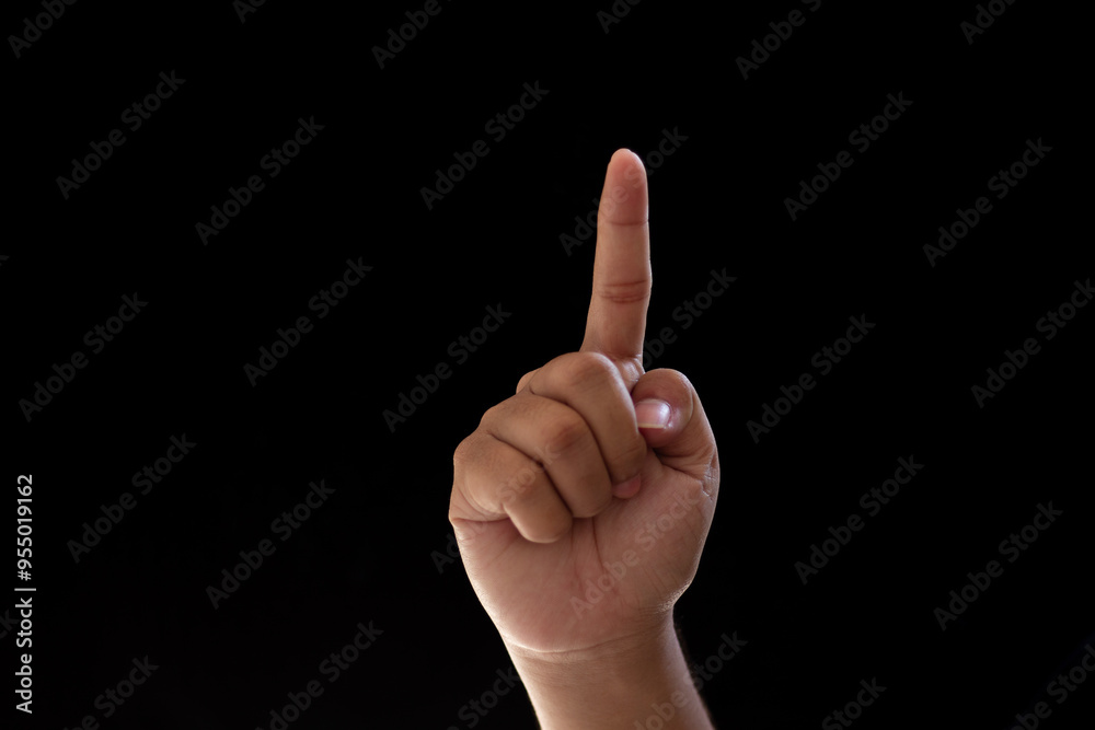 Close-up of one hand pointing or indicating the number one. Isolated photo on black background Close-up of one hand pointing or indicating the number one. Isolated photo on black background