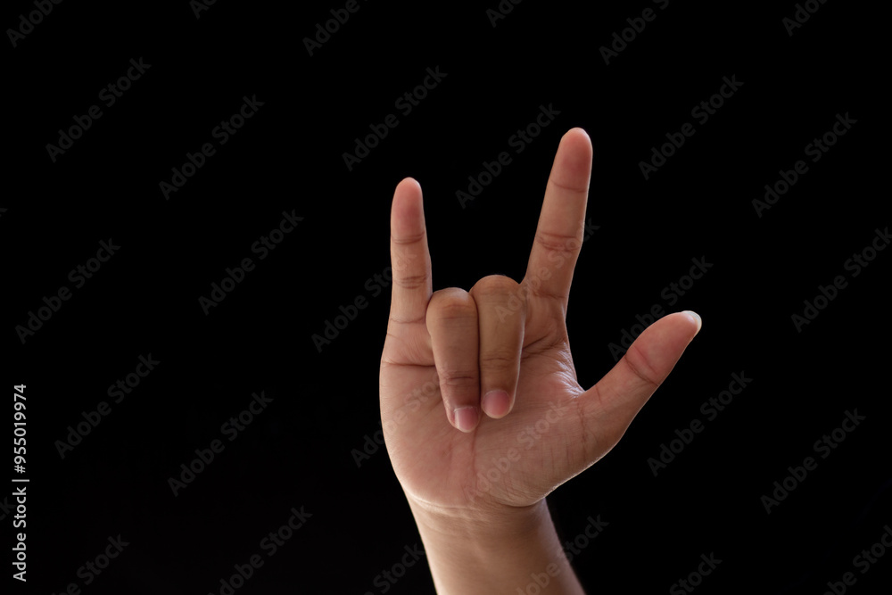 Close-up of one hand showing metal or rock. Photo isolated on black background Close-up of one hand showing metal or rock. Photo isolated on black background
