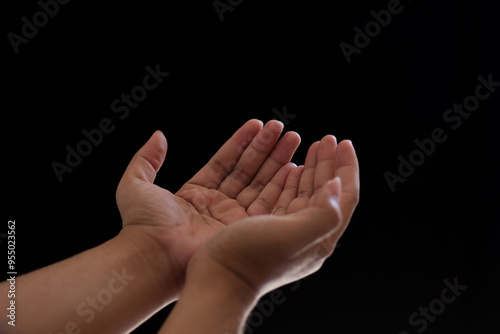 Close-up of two hands showing supplication or prayer. Photo isolated on black background photo