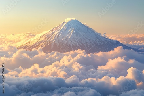 A distant snow-capped volcano rising above the clouds photo