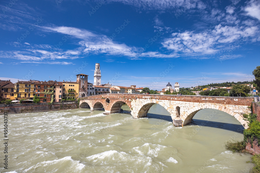 Fototapeta premium The Ponte Pietra roman arch bridge crossing the Adige River in Verona town, Italy, Europe.